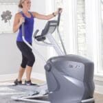 Octane Q35x Elliptical with model walking on it.