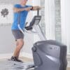 Octane Q35x Elliptical with model standing on it.