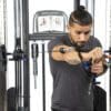 Bodycraft HFT Pro Functional Training Gym with model doing single arm chest press.