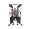 Bodycraft HFT Pro Functional Training Gym with model doing standing incline chest press (retracted).