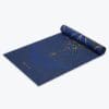 Reversible Metallic Sun & Moon Yoga Mat - 6mm rolled up showing sun/moon side.