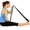 TEETER - T3 Massager with model using strap to pull their toes in while sitting.