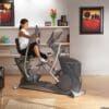 Octane XR6 Classic Seated Elliptical with Model doing seated elliptical workout.