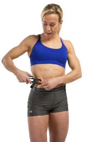 GoFit Body Fat Calipers with female model measuring stomach fat.