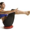 GoFit Core Stability and Balance Disk with model doing bent knee boat yoga pose.