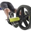 GoFit Extreme Ab Wheel on female model's feet doing pushups.