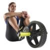 GoFit Extreme Ab Wheel on female model's feet doing seated knee pull ins.