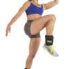 GoFit Padded Pro Ankle Weights with model doing knee up jump.