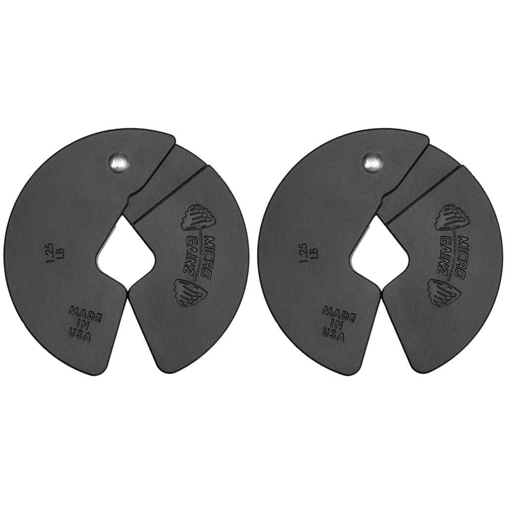 Pair of black magnetic weight plates with a cutout design, used for incremental weight adjustments in strength training.