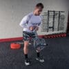 A person performing a bicep curl exercise with a barbell, focusing on building arm strength in a gym setting.