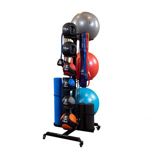 A gym storage rack holds stability balls, medicine balls, foam rollers, and mats for organized fitness equipment storage.